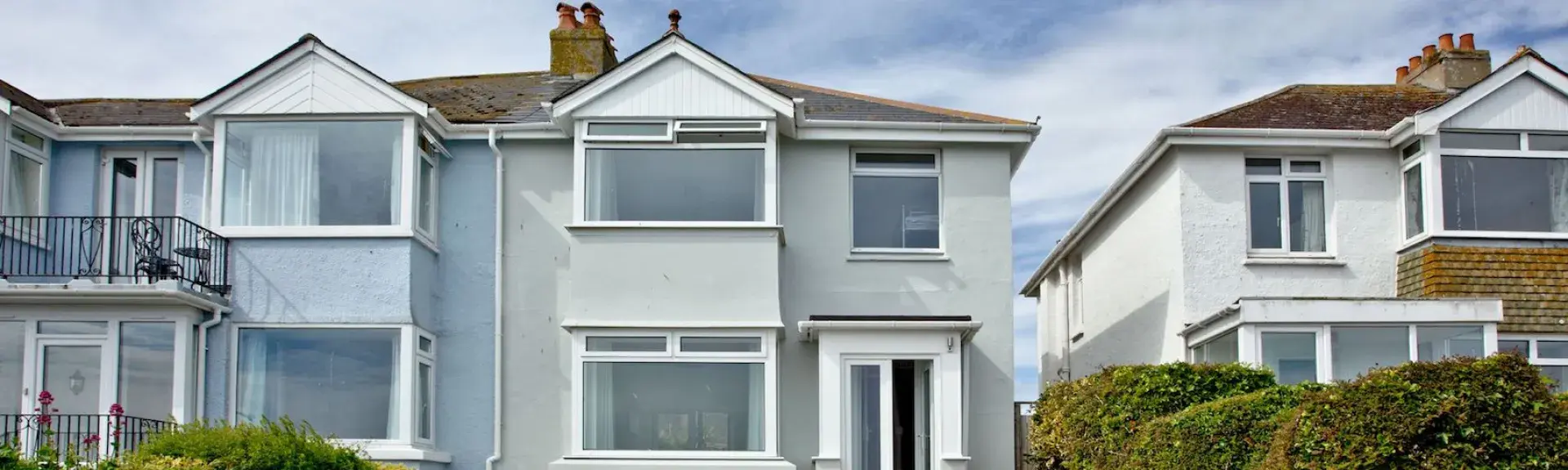 Exterior of a 2 storey detached house overlooking a garden and driveway.