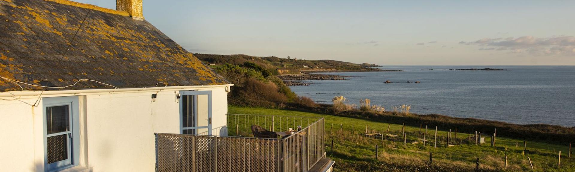 A two storey Marazion holiday cottage overlooks a lawned garden and sweeping sea views.