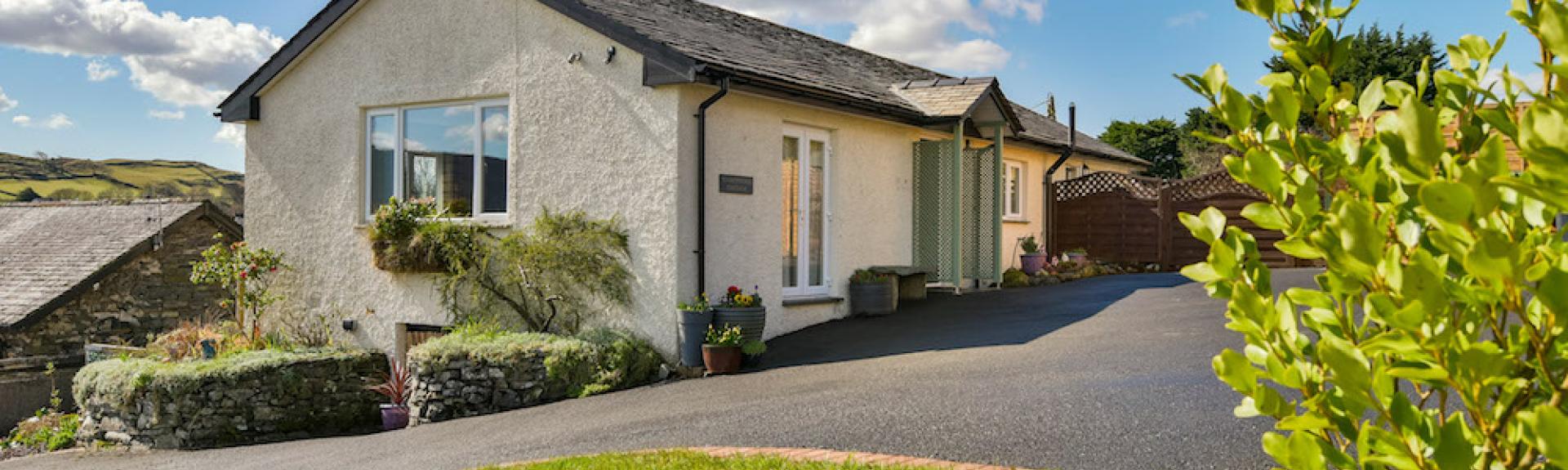 A Coniston holiday bungalow with a lawn and large tarmac space for guest's cars