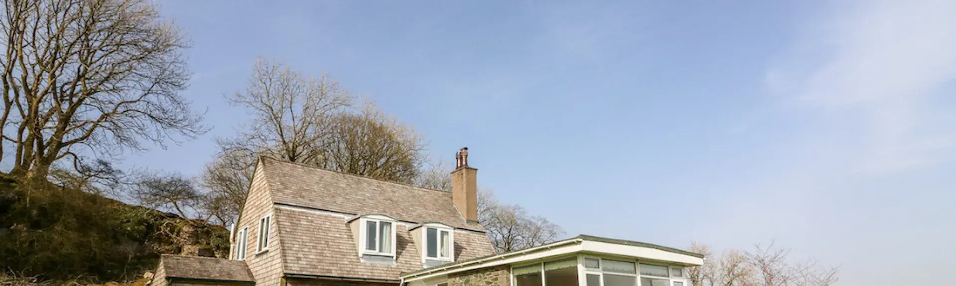 Exterior of an Ingleton holiday cottage overlooking a garden in a rural location.