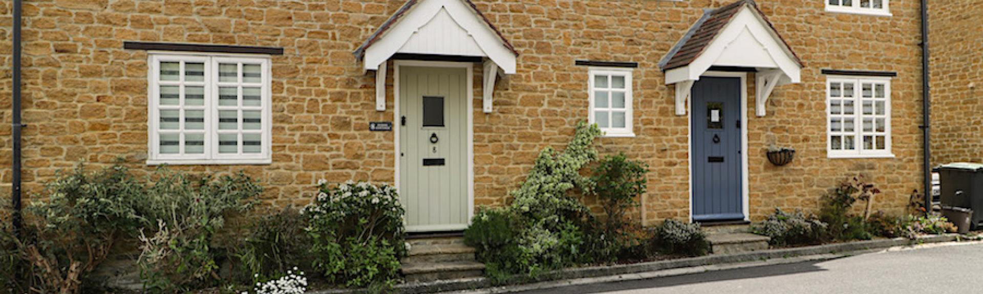 A semi-detached stone-built holiday cottage in Chideock overlooks a quiet village lane.