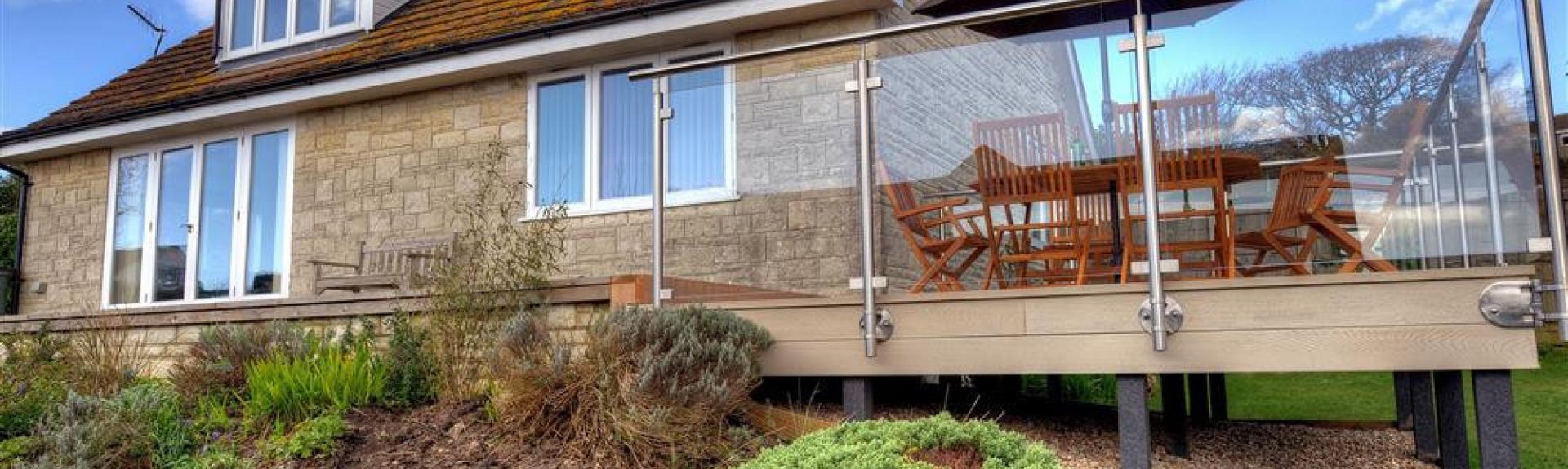 A large multi-windowed chalet bungalow in Charmouth with an extended plate-glass walled deck