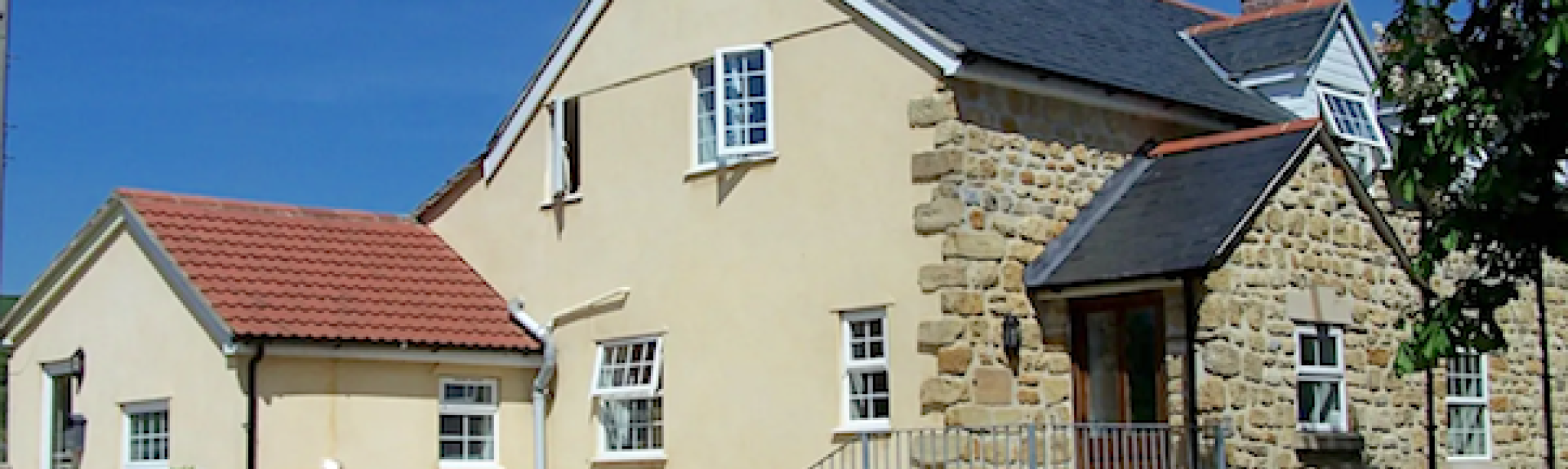 2-storey exterior of a stone-built, large Dorset holiday cottage