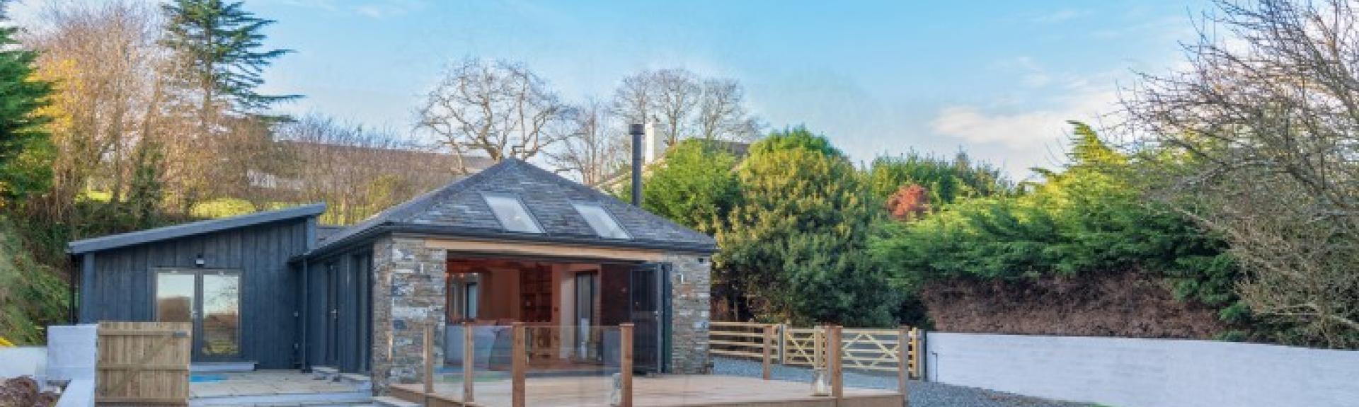  single-storey South Devon barn conversion overlooks a courtyard and a hot tub