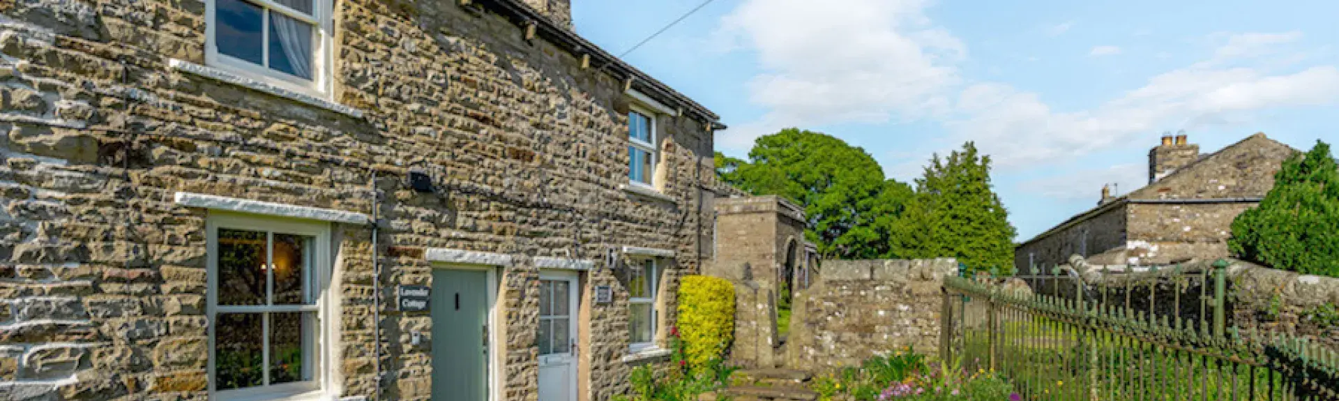 Terraced village cottages overlook a continuous front lawn.