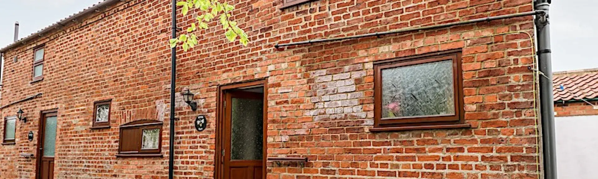 2-storey brick cottage overlooks a quiet street.