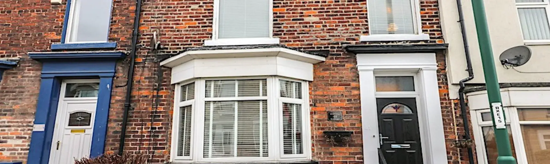 2-storey Victorian town house with bay windows and small front garden