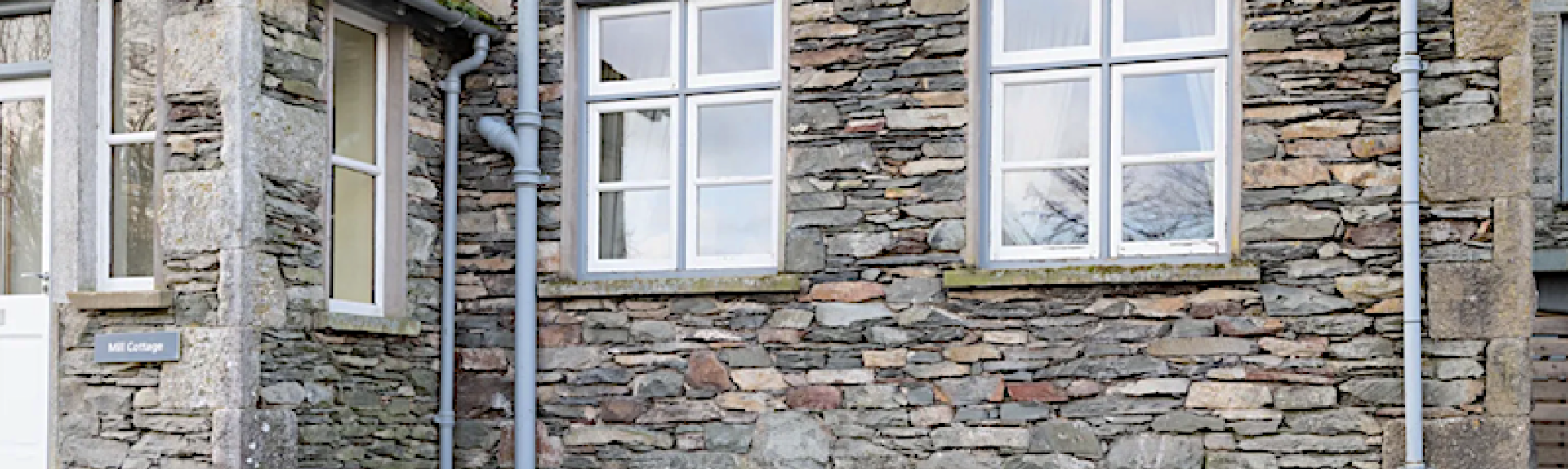 Exterior of a stone-built holiday cottage in the Lake District.