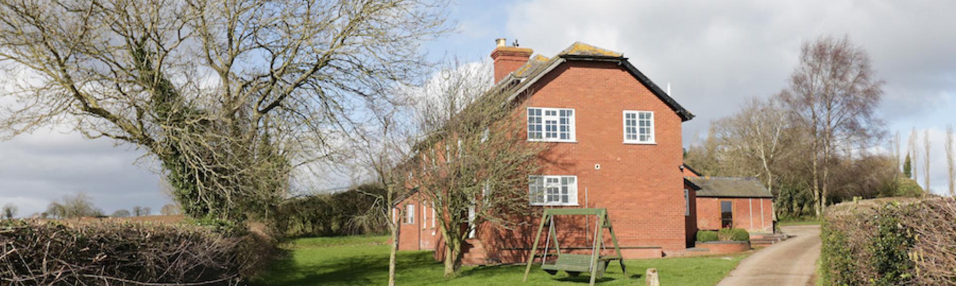 A drive leads to a brick-built Herefordshire country cottage.