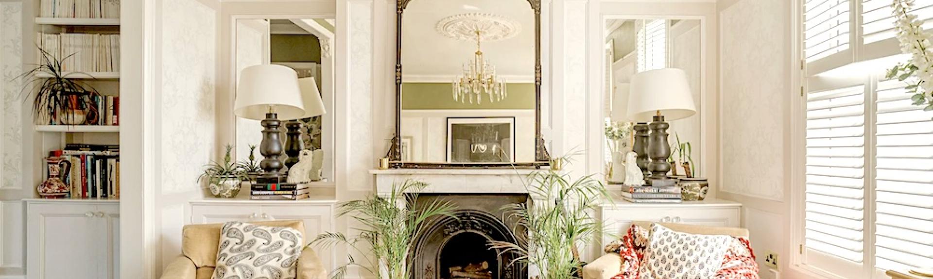 A lounge with a feature fireplace between two armchairs.