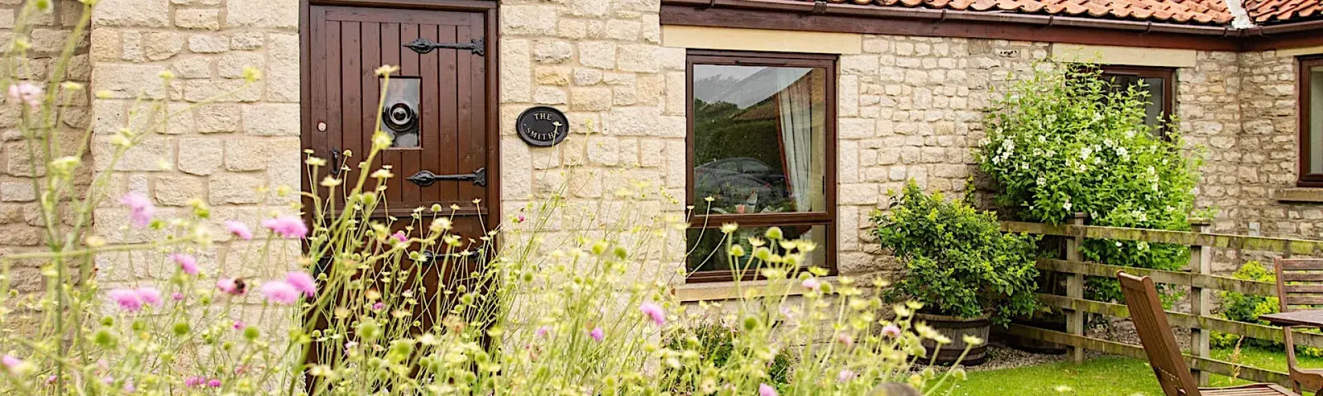Single storey of a barn conversion overlooking a lawn on a North Yorkshire farm.