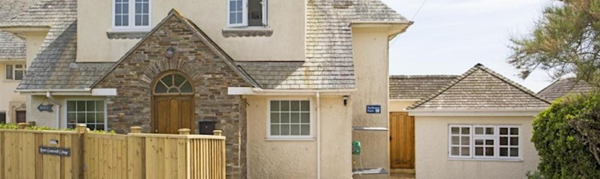 Front exterior of a 2-storey holiday home in Thurlestone with a wide drive for parking.