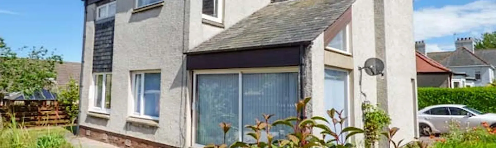 Exterior of a contemporary house with sliding windows onto a patio