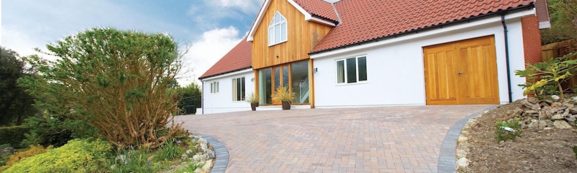Large modern chalet bungalow approached by a spacious block paved drive.
