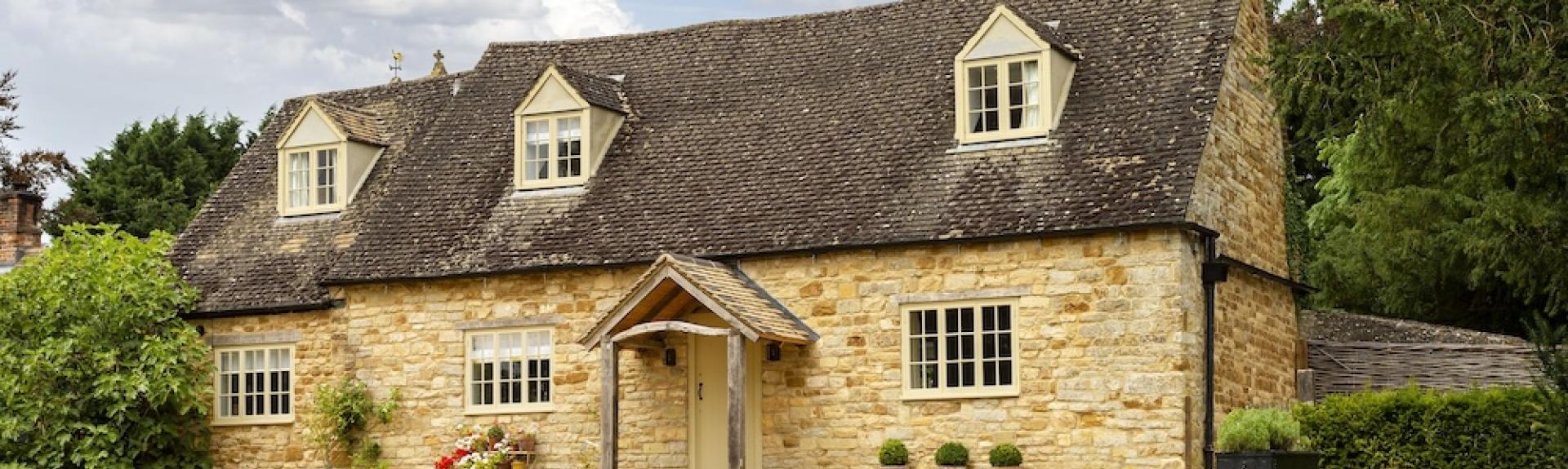 A 2-storey Cotswold honeystone cottage overlooking a spacious lawn.