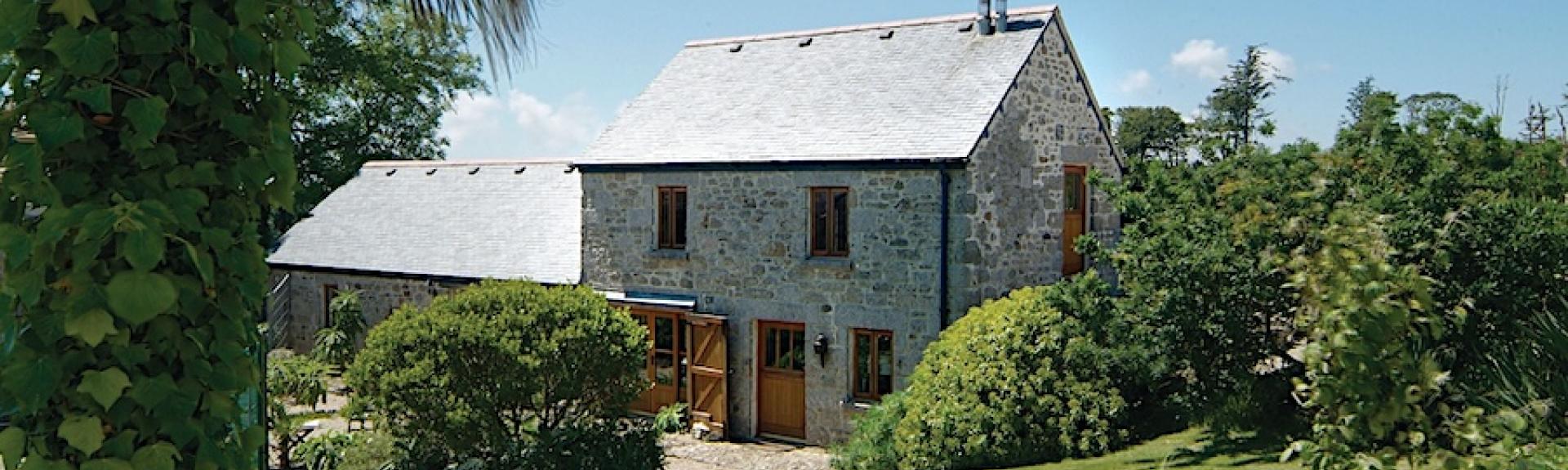 A 2-storey Cornish Barn conversion overlooks well-kept lawns and gardens.