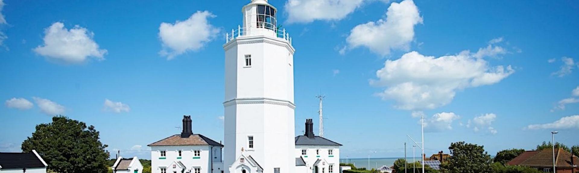 A clifftop lighthouse complex in Kent with well-kept lawns.