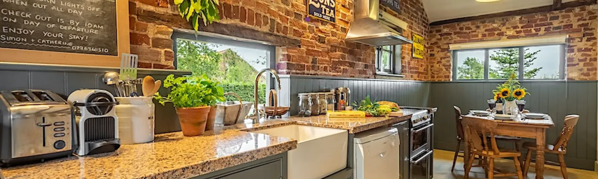 Kitchen worktops and dining table in a Norfolk cottage with oak-beamed ceilings.