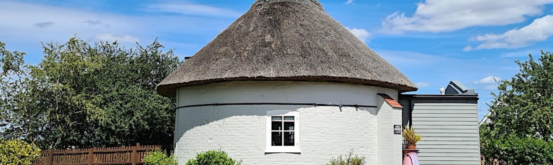 Circular exterior of cottage created within the base of a Suffolk windmill