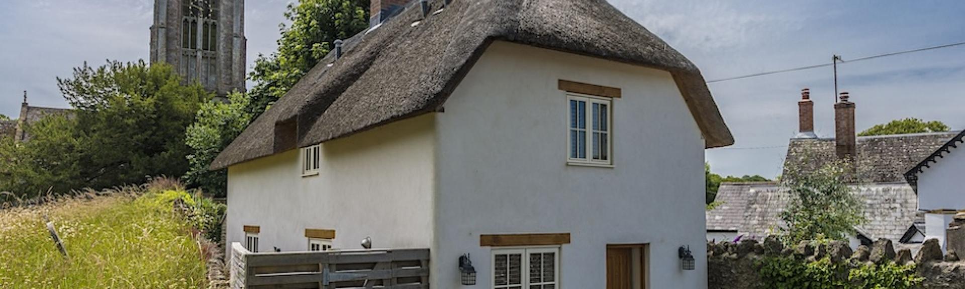 Exterior of a thatched village cottage in Dorset.