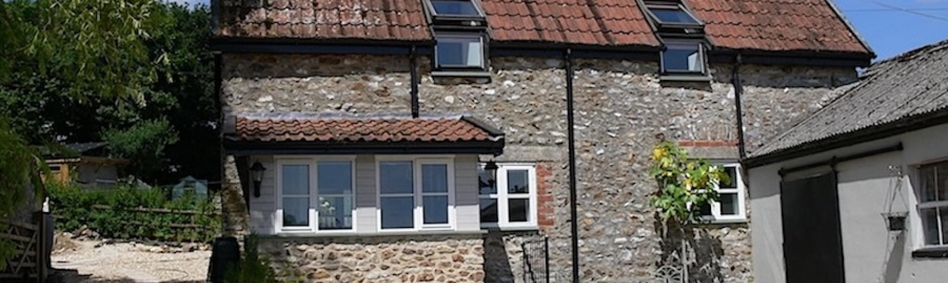 A 2-storey, stone-built East Devon holiday cottage overlooks a shingle covered courtyard.
