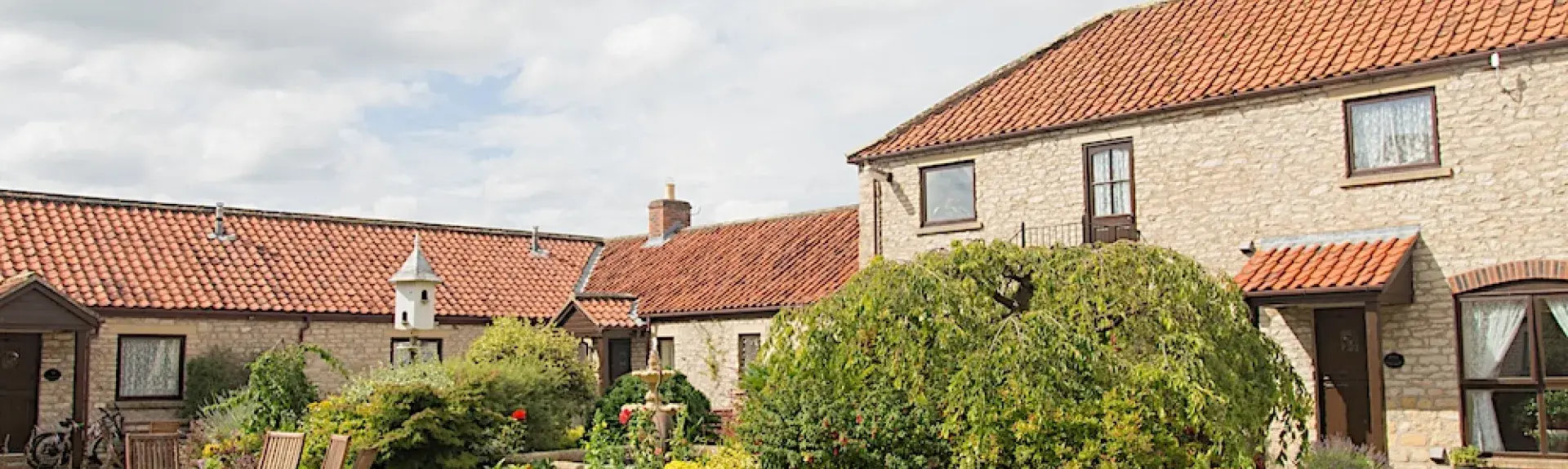 Exterior of a barn conversion overlooking a garden courtyard