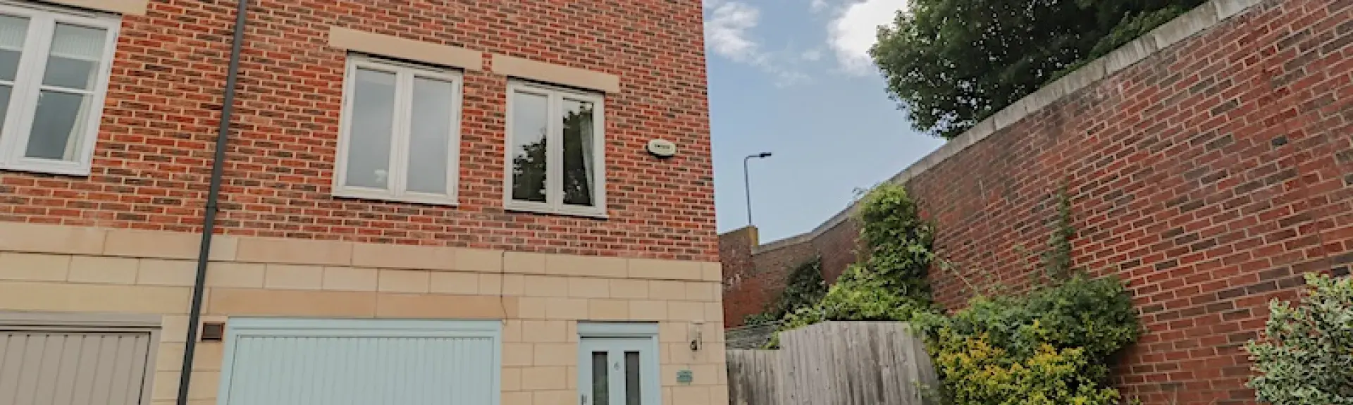 3-storey exterior of a Whitby holiday home with a garage on the ground floor