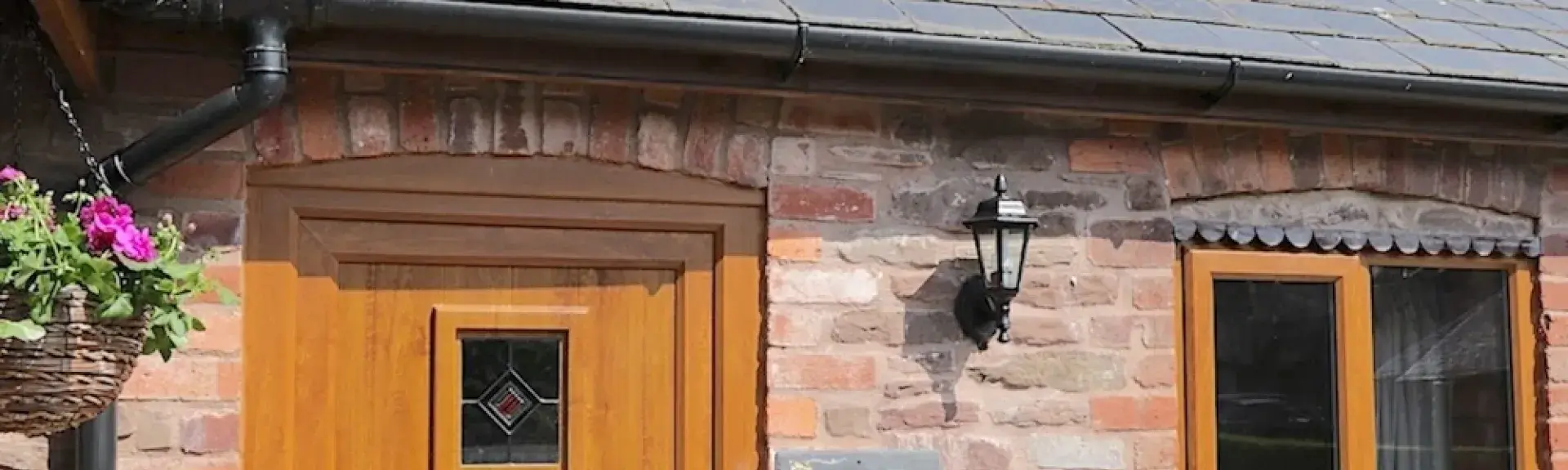 Exterior of a slate-roofed, single-storey barn conversion in Leominster.