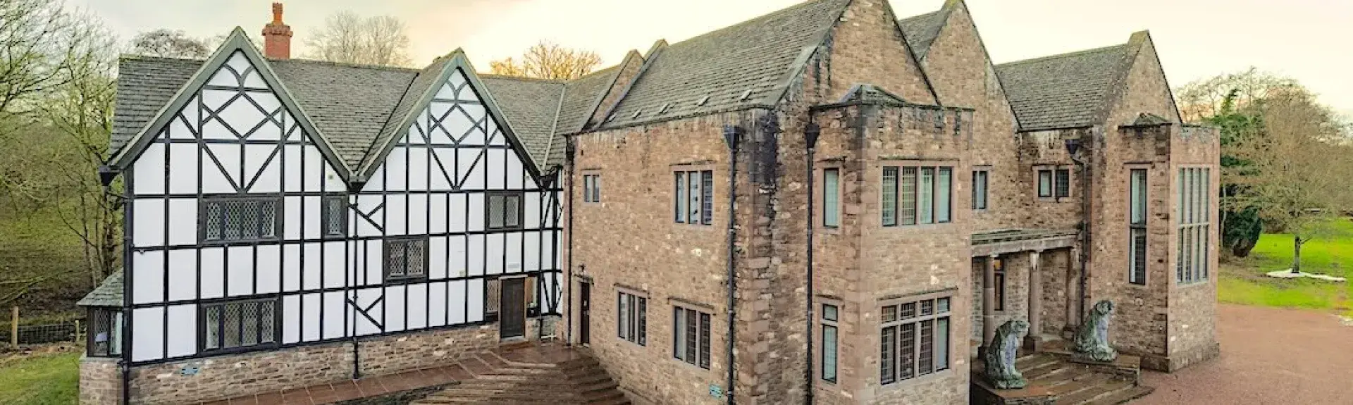 A large country Manor house with a timbered Tudor wing.