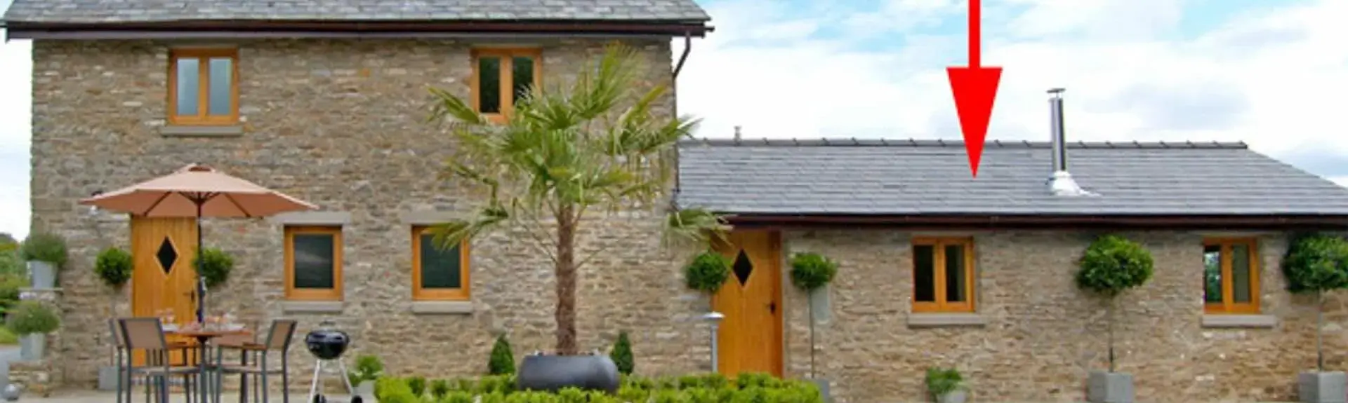 A 2-storey house with a single-storey wing, overlooks a courtyard with a BBQ terrace.