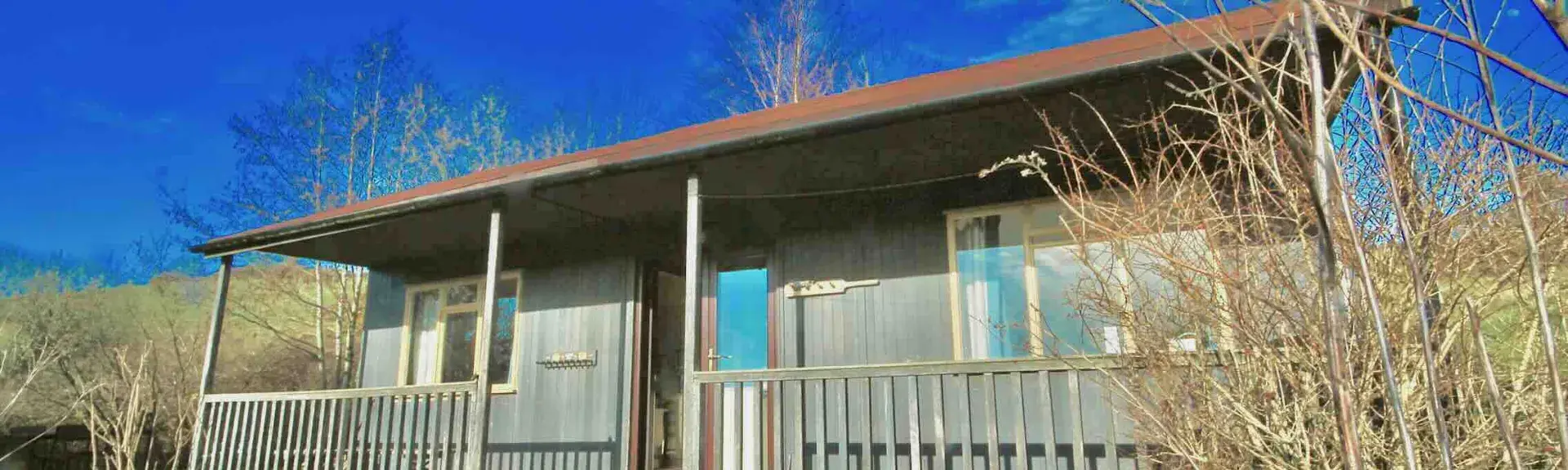 A cricket pavilion with a verandah converted to a holiday lodge.