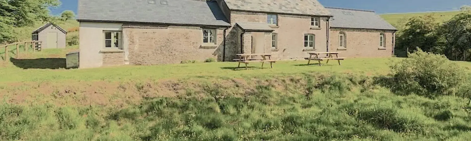 The exterior of a stone-built Exmoor farmhouse in a remote moorland location.