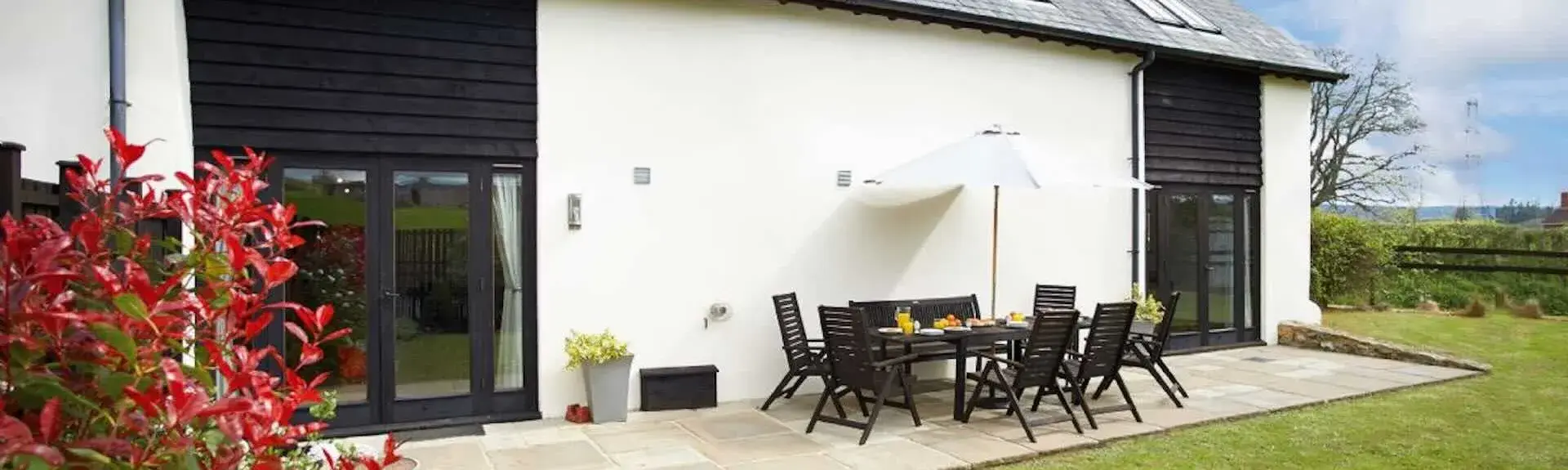 A large single storey barn with a private, secure, hedge-lined lawn.