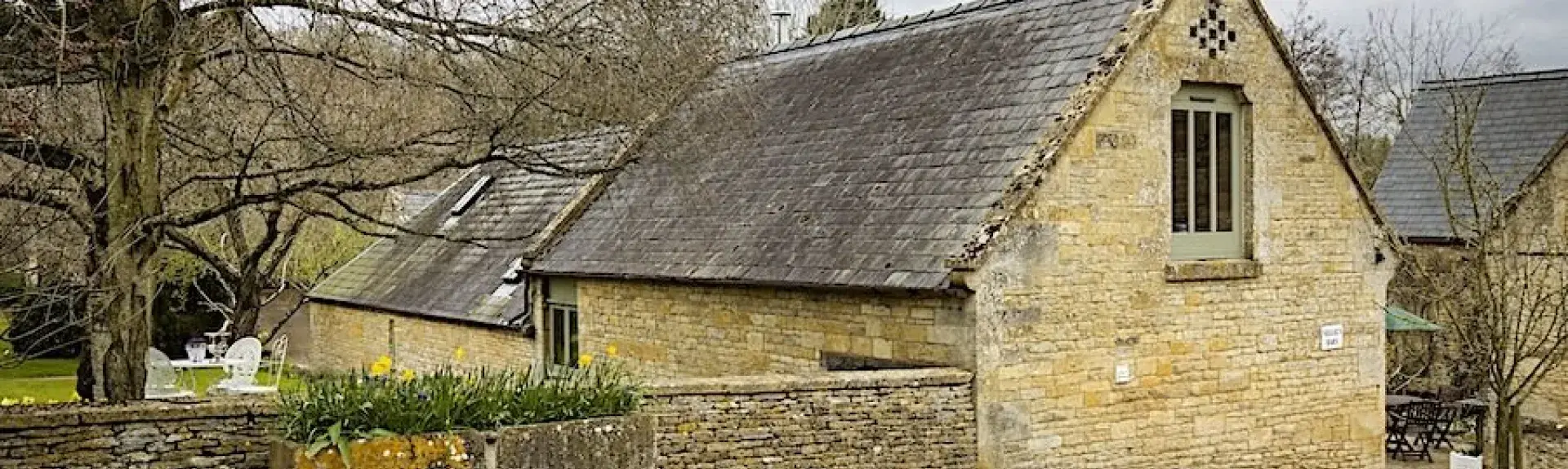 A Luxury Cotswold Farm Barn Conversion within a walled garden.