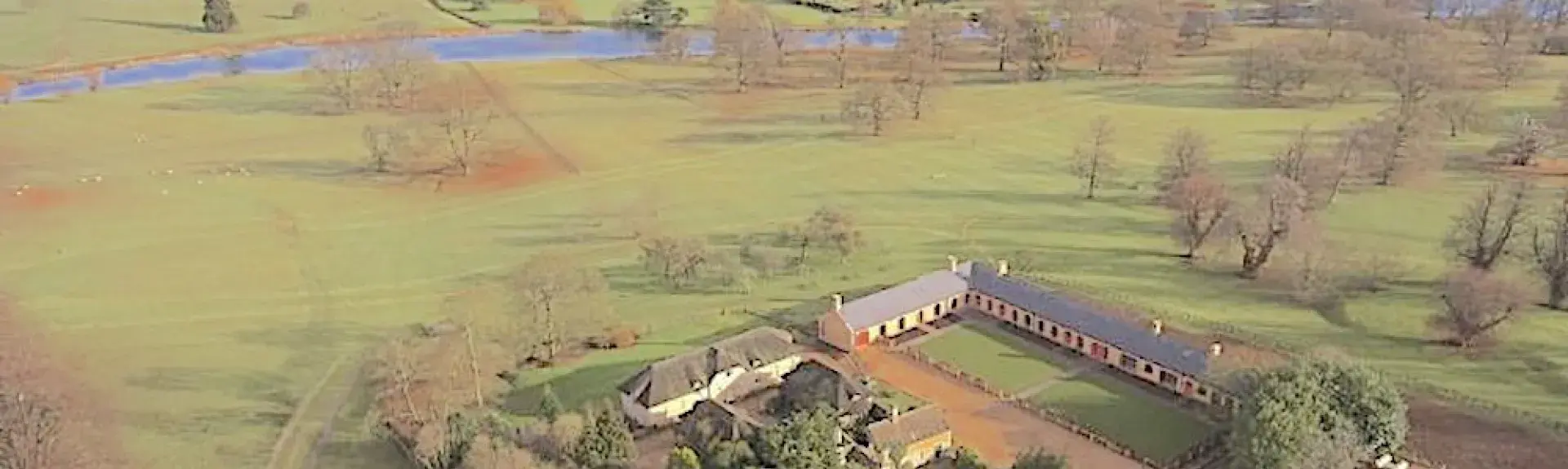 Aerial view of the flat Lincolnshire countryside with a group of luxury stable conversions surrounding a large courtyard.