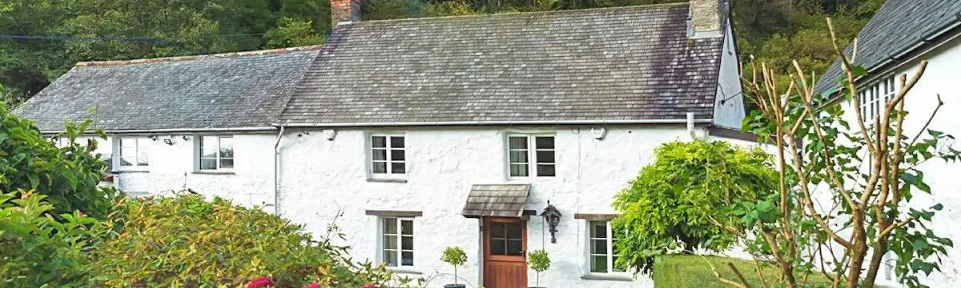 A large old mill cottage nestles in a wooded Exmoor valley.
