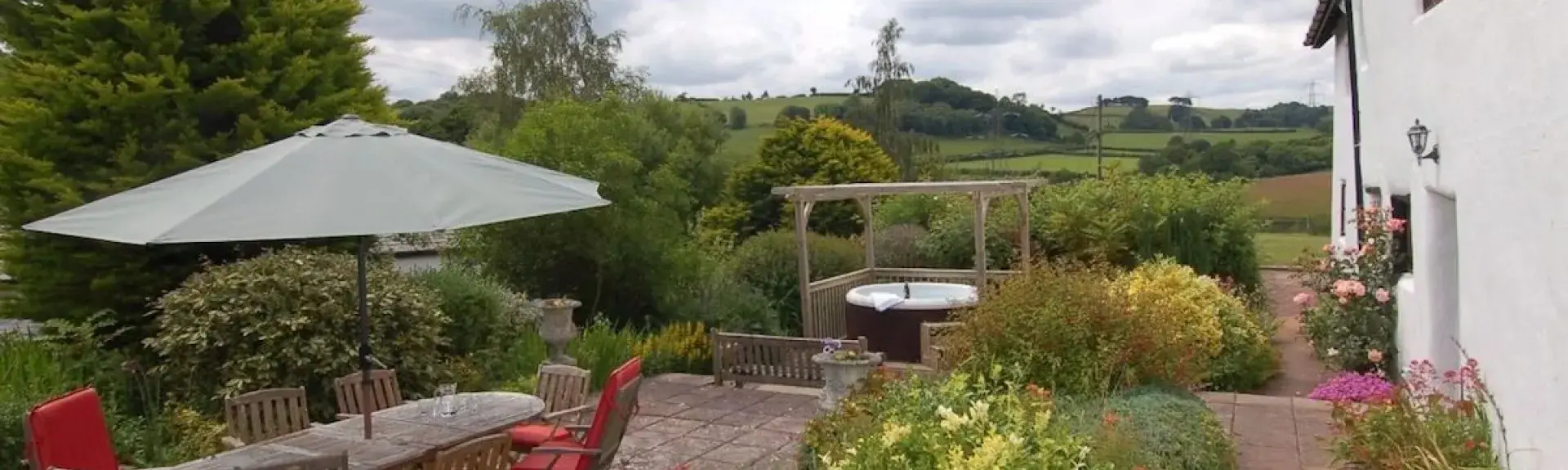 A flower-filled garden with rural views alongside a Somerset holiday cottage. 