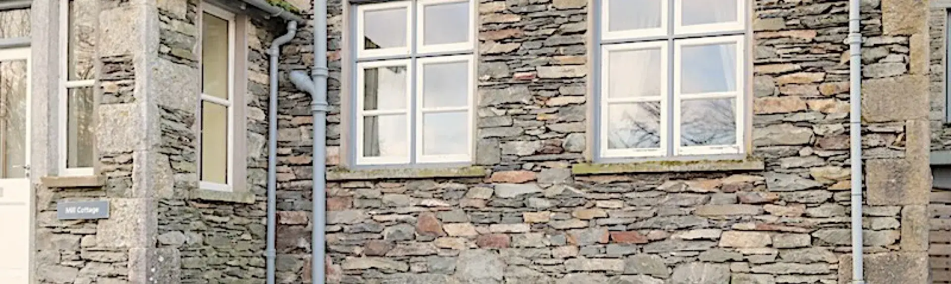 Exterior of a stone-built holiday cottage in the Lake District.