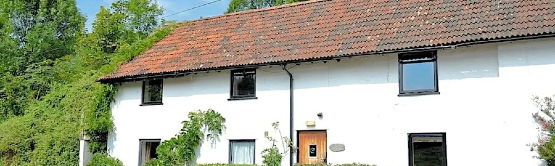 An Exmoor cottage overlooks a quiet country lane.