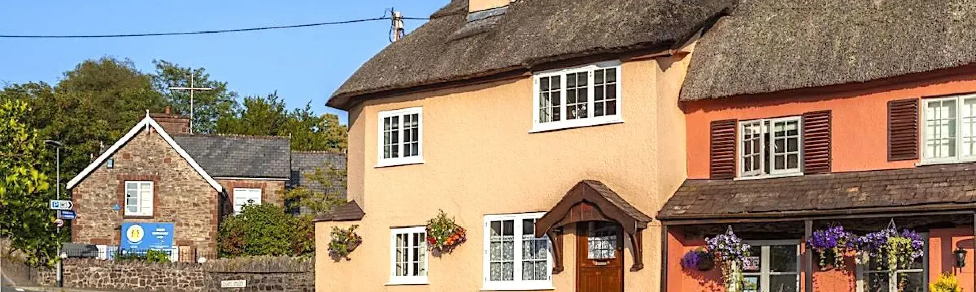 A thatched holiday cottage faces the village green in Exford.