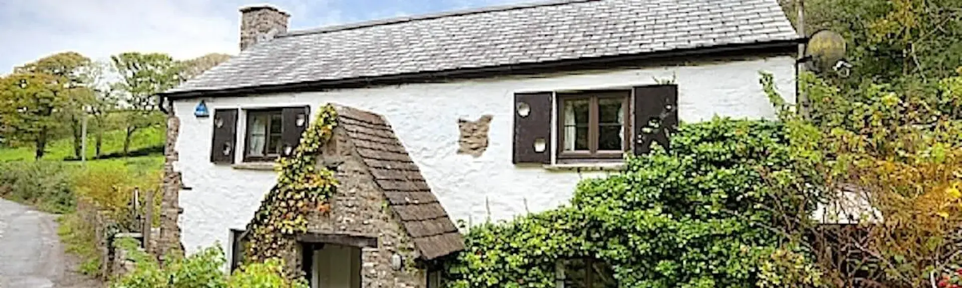 A secluded country cottage with an ivy clad exterior on a quiet country lane.