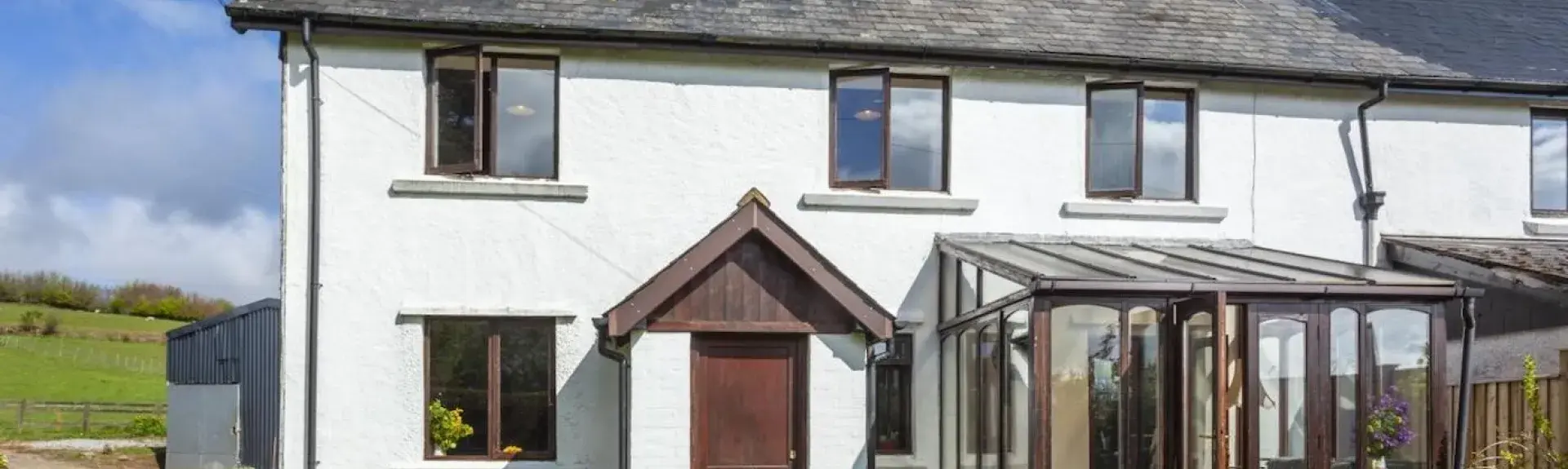 Semi-detached Exmoor country cottage with conservatory and lawned garden.