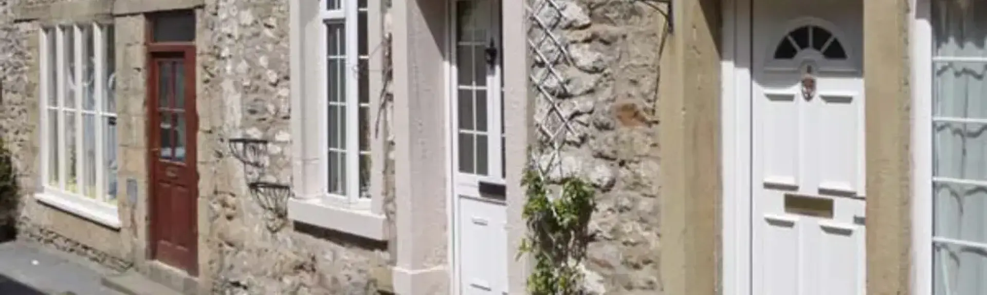 Ground floor street exterior of a stone-built terraced holiday cottage in Settle
