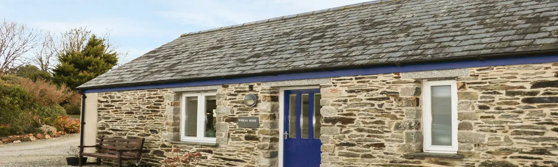 A ground-floor rural barn conversion in Cornwall overlooks a shingle-covered courtyard.