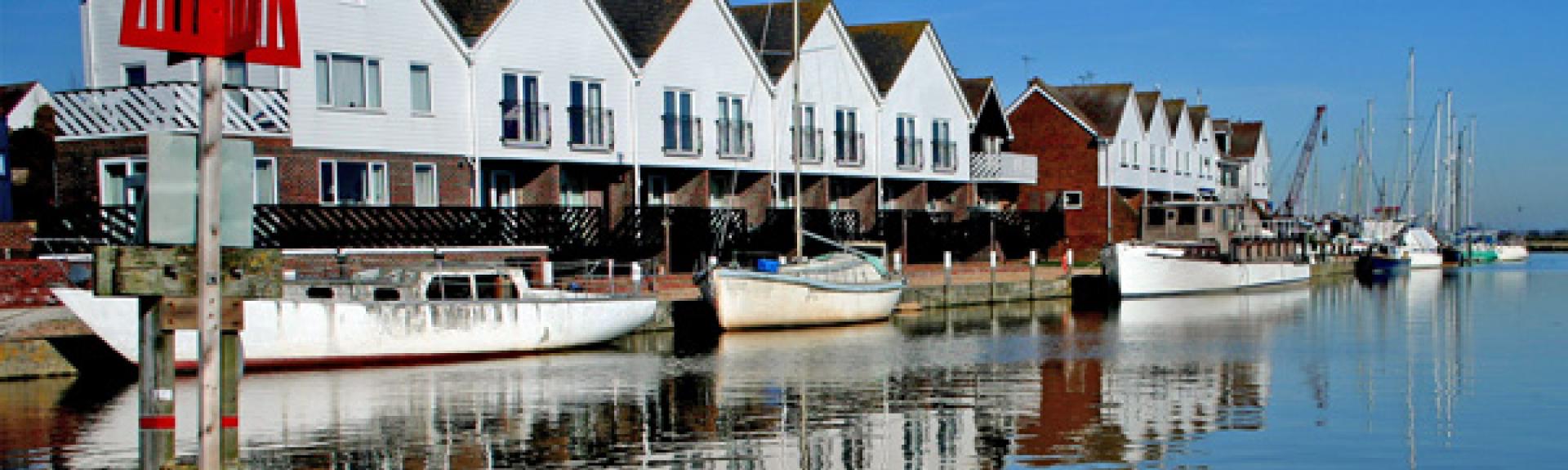 Quayside holiday apartment in Rye overlooks small craft moored to the waterfront at high tide