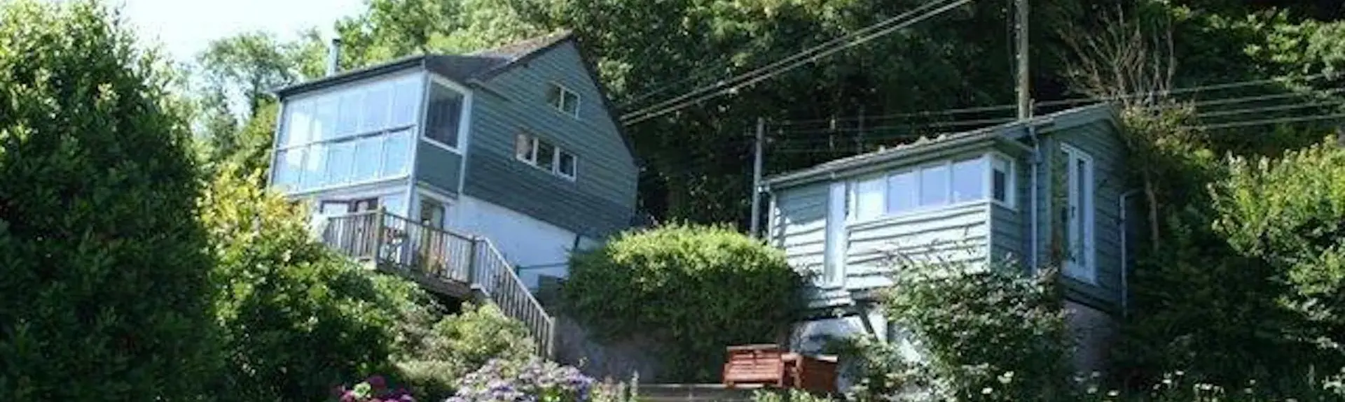 Country Cottage with large garden overlooked by a steep, wooded hill
