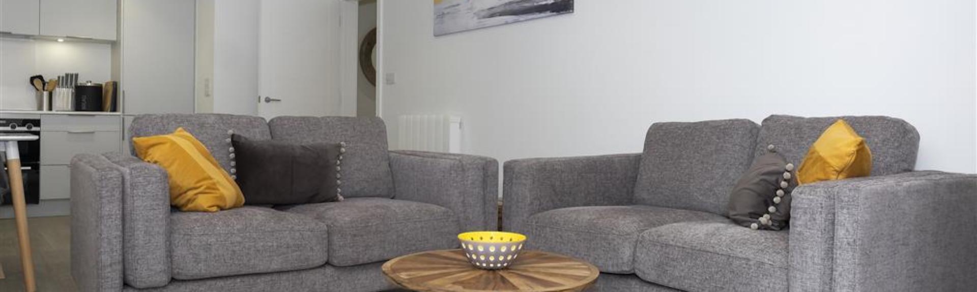 Comfortable cotton sofas in an open-plan living area