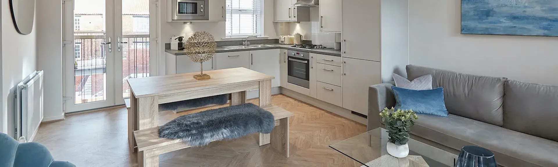 A light and spacious, lavishly furnished open-plan living area, with original artwork on the walls.