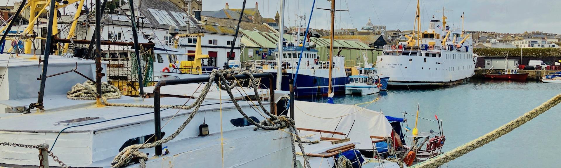 Enjoy a walk inspecting the boats moored in Penzance Harbour 