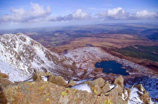 Village Holidays in Snowdonia aerial view across Snowdonian mountain tops, crags and valleys on a clear winter's day